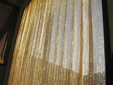 The golden color metallic fabric cloth is installed on the window.