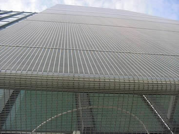 The crimped architectural mesh is covering the high building.