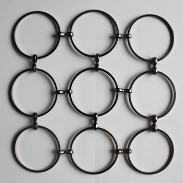 A piece of low carbon steel S hook metal ring mesh with round wire on the gray background.