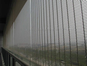 Stainless steel crimped architectural mesh is installed on the windows of building.
